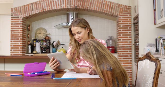 Mother and Daughter Doing Homework in Kitchen - Download Free Stock Images Pikwizard.com