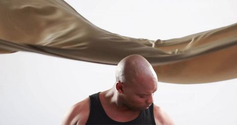 Athletic african american man exercising with dynamic fabric motion