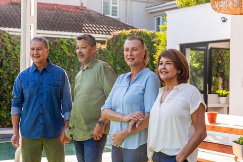 Group of Friends Socializing Outdoors by Modern Poolside
