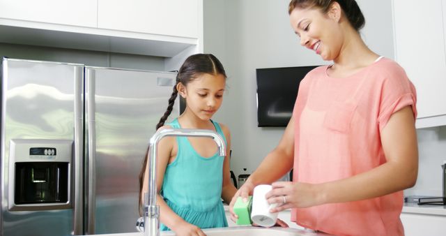 Mother and Daughter Doing Dishes Together in Modern Kitchen - Download Free Stock Images Pikwizard.com