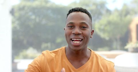 Cheerful African American Man Videocalling at Home
