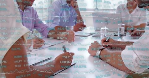 Financial data overlays with diverse business team collaborating