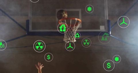 Reaching hand grabbing basketball at rim with green environmental icons floating over court