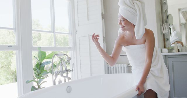 Woman Preparing Bathtub for Relaxing Bath in Bright Modern Bathroom - Download Free Stock Images Pikwizard.com