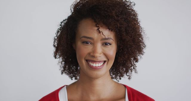 Smiling Woman with Curly Hair in Red Sweater - Download Free Stock Images Pikwizard.com