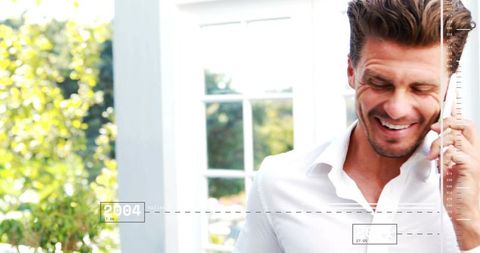 Smiling businessman talking on phone beside french doors with ui overlay and sunny garden