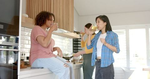 Diverse Group of Female Friends Bonding in Modern Kitchen