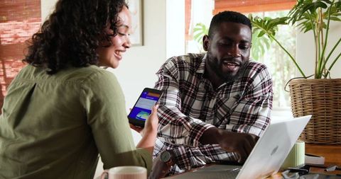 Diverse coworkers collaborating on digital project in modern office