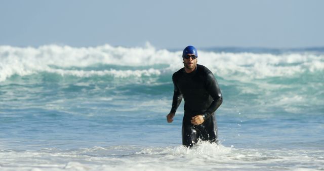Male Surfer Wearing Wetsuit Stands in Ocean Waves - Download Free Stock Images Pikwizard.com
