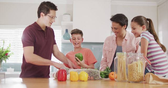 Family is unpacking groceries together, highlighting a moment of connection and collaboration. Fresh vegetables on the counter emphasize healthy living. Useful for concepts related to family life, healthy eating, teamwork, and domestic lifestyles.