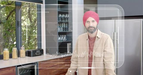 Indian man in red turban presenting hud analytics overlay on modern sunlit kitchen counter