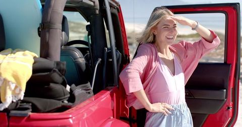 Young Woman Enjoying Sunny Day on Carefree Road Trip
