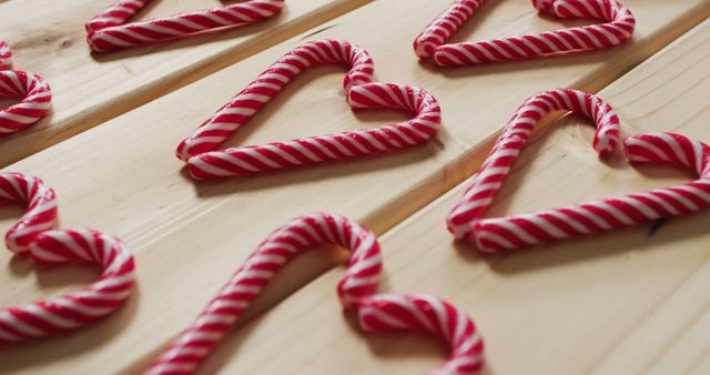 Image of red and white candy canes on wooden background - Download Free Stock Photos Pikwizard.com