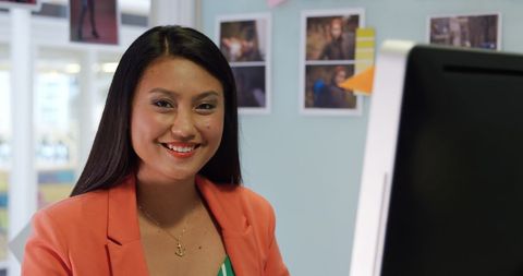 Smiling Businesswoman Using Computer in Creative Office