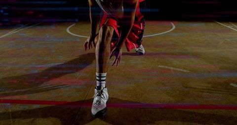 Basketball player lunging on neon court showing explosive footwork and motion