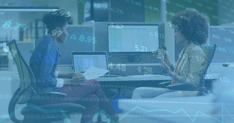 Diverse Professionals Discussing Financial Data Insights in Modern Office