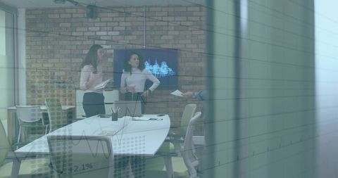 Team Presenting Business Data on Glass Wall in Modern Daylit Office Meeting