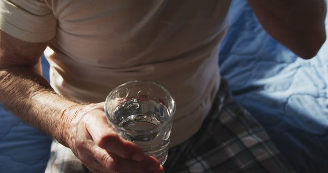 Senior Man Holding Glass of Water in Morning Light - Download Free Stock Images Pikwizard.com