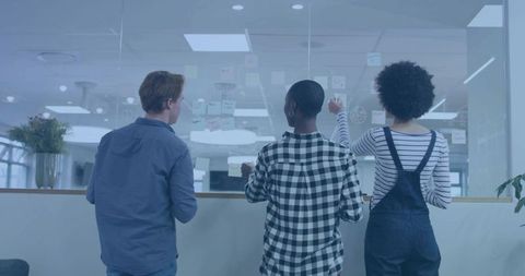 Collaborative Team brainstorming with Sticky Notes in Modern Office