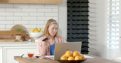 Modern home office setup with young woman balancing digital tasks