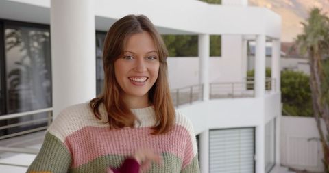 Smiling Woman in Vibrant Knit Sweater Outdoors