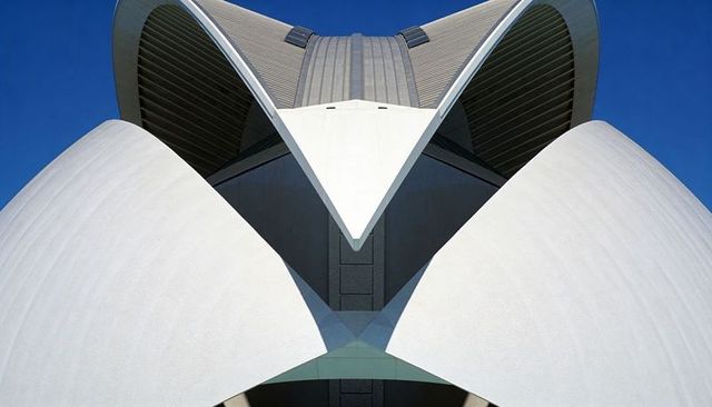 Sculptural White Curved Shells Rising to Central Apex Against Deep Blue Sky