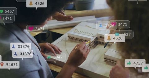 Design team collaborating over architectural scale model with social media engagement overlays