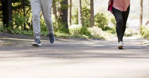 Senior Couple Jogging Outdoors with Water Bottle in Sunny Park - Download Free Stock Images Pikwizard.com