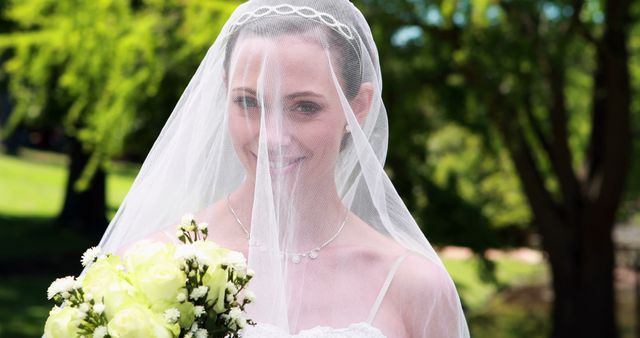 Beautiful Bride Smiling Through Veil Holding Bouquet on Sunny Wedding Day - Download Free Stock Images Pikwizard.com