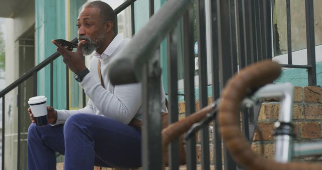 Businessman taking voice notes during coffee break outdoors - Download Free Stock Images Pikwizard.com