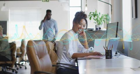Confident Professional Woman at Work in Open-Plan Office