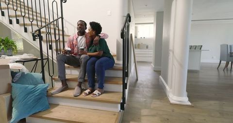 Happy Couple Enjoying Coffee Break During Home Moving Day