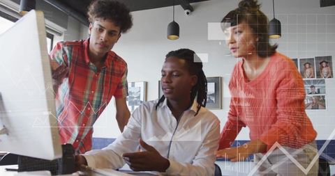 Collaborating team reviewing charts on monitor in modern office for data-driven decisions