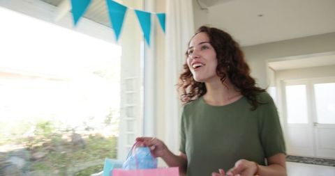 Woman Enjoying Baby Shower with Joy and Gifts at Home