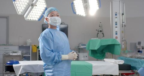 Confident Surgeon in Modern Operating Room Preparing for Procedure