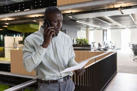 Professional Reviewing Document on Office Balcony