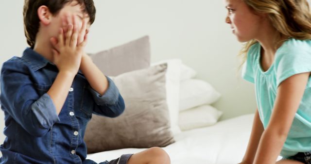 Upset Boy Covering Face While Girl Stares on Bed - Download Free Stock Images Pikwizard.com