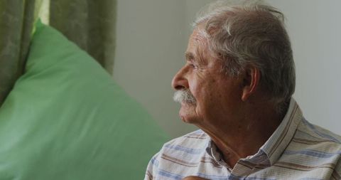 Elderly Man with Cane Looking Thoughtfully Outdoors