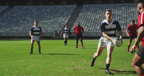 Intense Rugby Match Action on Sunny Day in Stadium