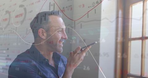 Businessman Dictating on Smartphone with Financial Charts Overlay