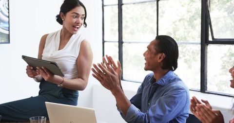 Diverse Colleagues Celebrating in Office Meeting