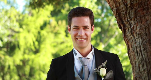 Groom Standing by Tree Smiling at Camera on Sunny Wedding Day - Download Free Stock Images Pikwizard.com