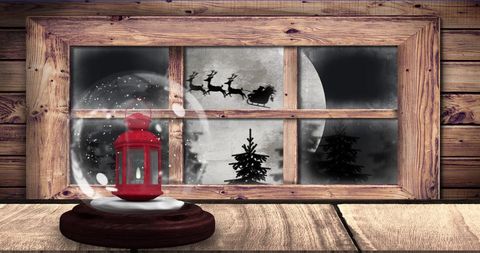 Magical christmas scene with lantern and santa silhouette