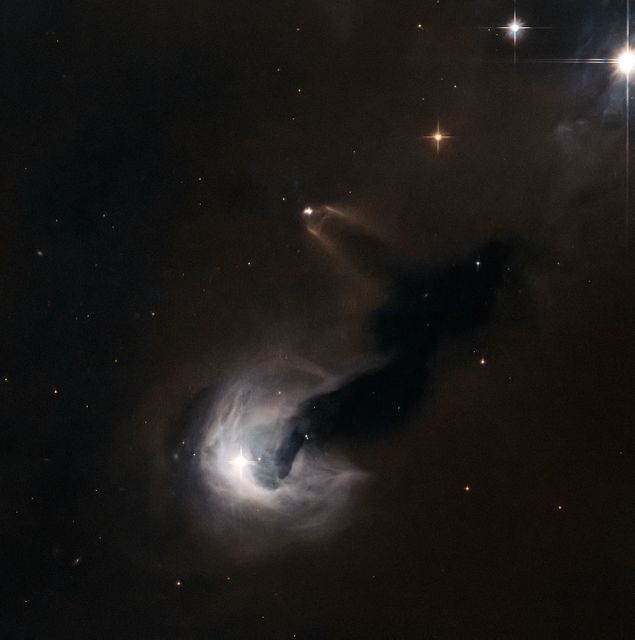 Image captures a young stellar object (YSO) in the constellation of Perseus, seen emanating bright bursts of gas. The scene is highlighted by the reflection nebula [B77] 63, lit by stars including LkHA 326 and LZK 18. A dark nebula, Dobashi 4173, appears as a stream of smoke obstructing the sky's patches. Ideal for understanding star formation, cosmic phenomena, and nebulae characteristics in astrophysics presentations or educational materials.