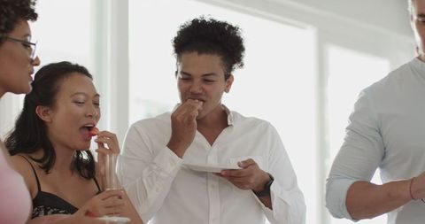 Friends Enjoying Food and Laughter at Lively Celebration