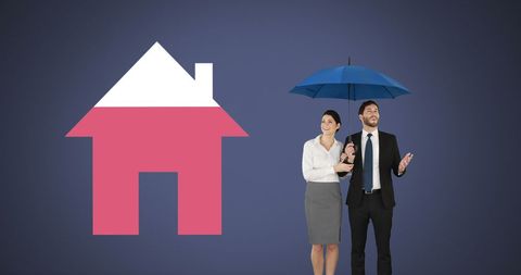 Business professionals holding umbrella next to house icon