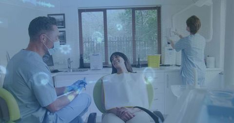 Dentist treating patient in modern dental clinic wearing mask and gloves, sterile operatory
