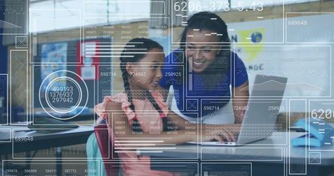 Teacher mentoring student using laptop with futuristic HUD overlays for classroom learning