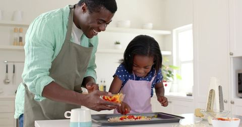 Father and Daughter Cooking Together in a Bright Kitchen