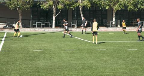 Youth soccer team practicing on green field